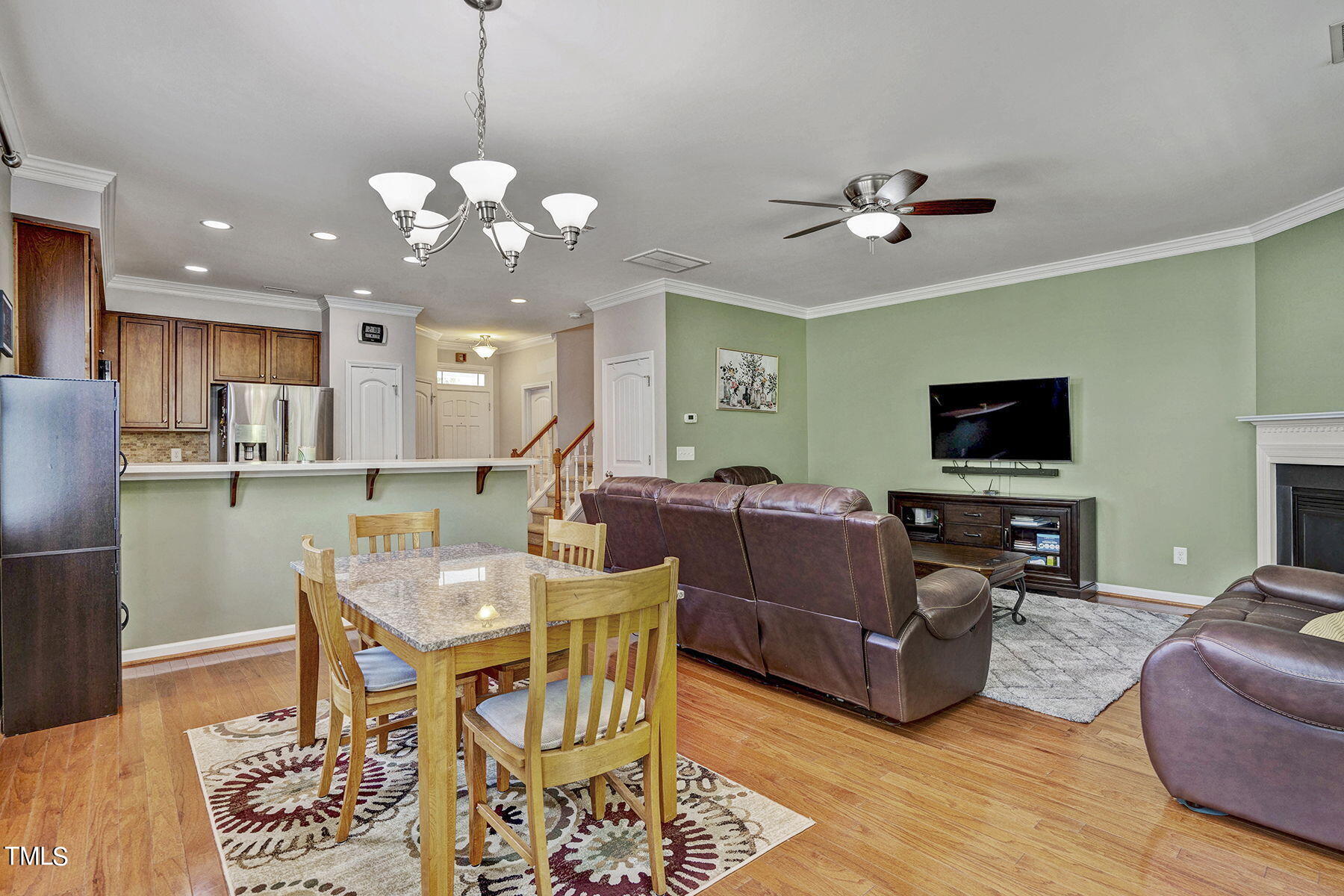 4630 Altha Street Raleigh, NC 27606 - Photo 15 of 31 a living room with furniture a dining table and a chandelier