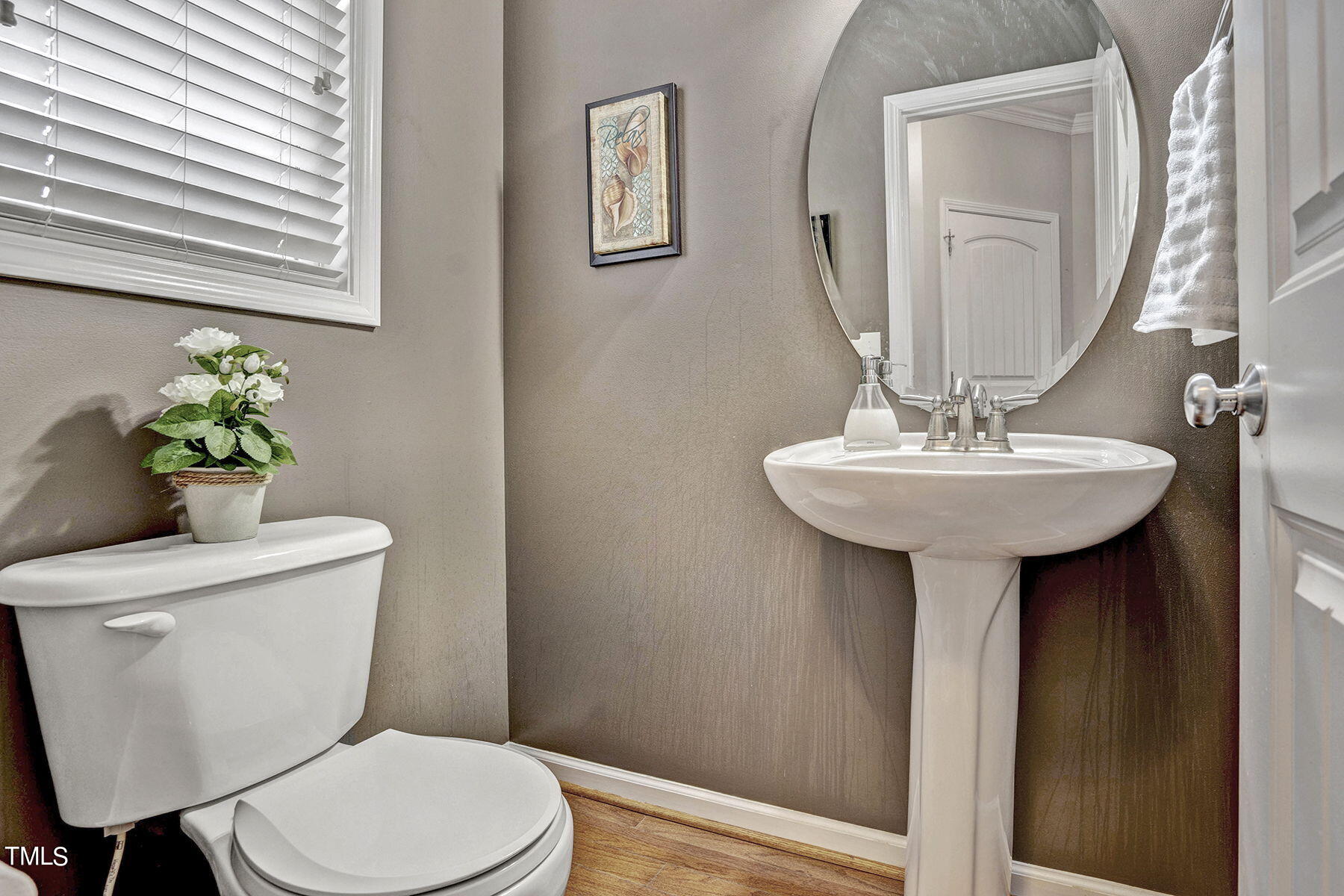 4630 Altha Street Raleigh, NC 27606 - Photo 17 of 31 a bathroom with a toilet sink and mirror