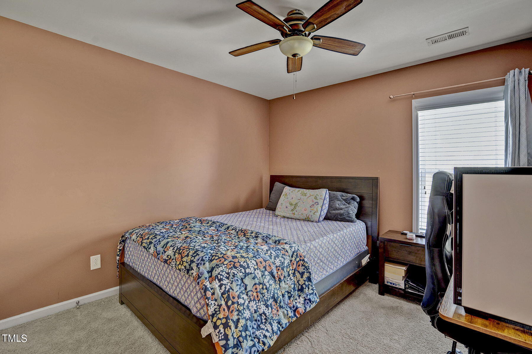4630 Altha Street Raleigh, NC 27606 - Photo 19 of 31 a bedroom with a bed and a chandelier
