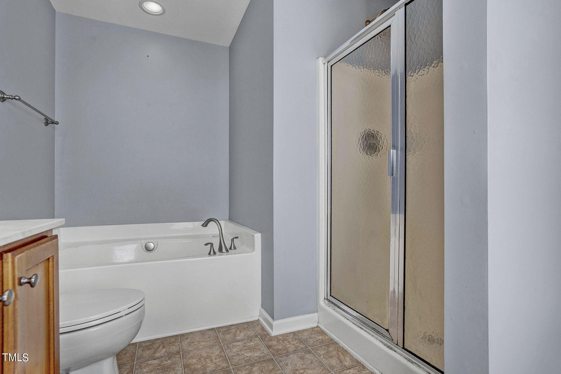 4630 Altha Street Raleigh, NC 27606 - Photo 25 of 31 a bathroom with a bathtub and a toilet