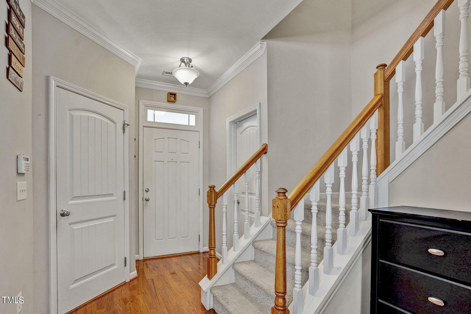 4630 Altha Street Raleigh, NC 27606 - Photo 4 of 31 a view of an entryway with wooden floor and stairs