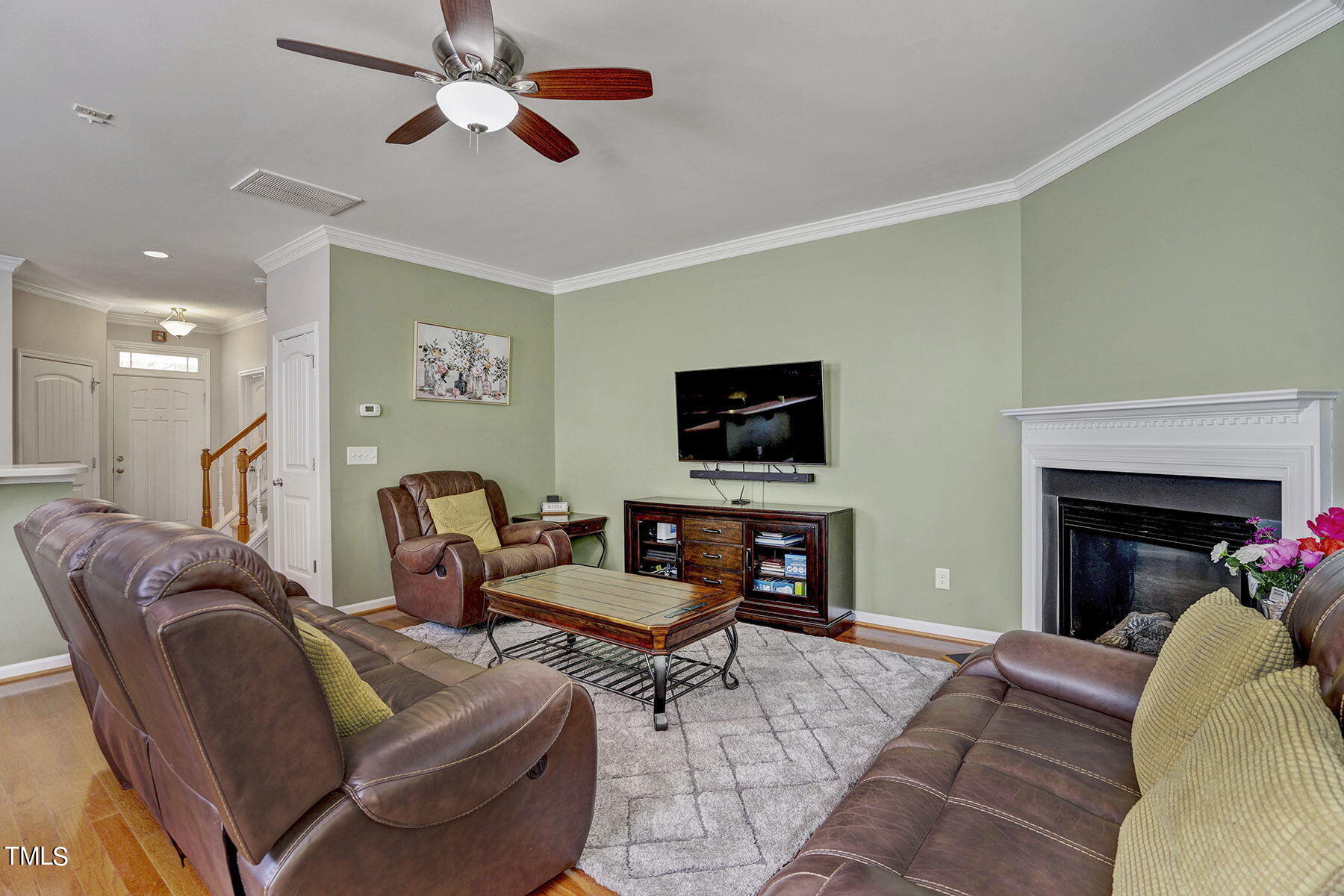 4630 Altha Street Raleigh, NC 27606 - Photo 8 of 31 a living room with furniture a flat screen tv and a fireplace
