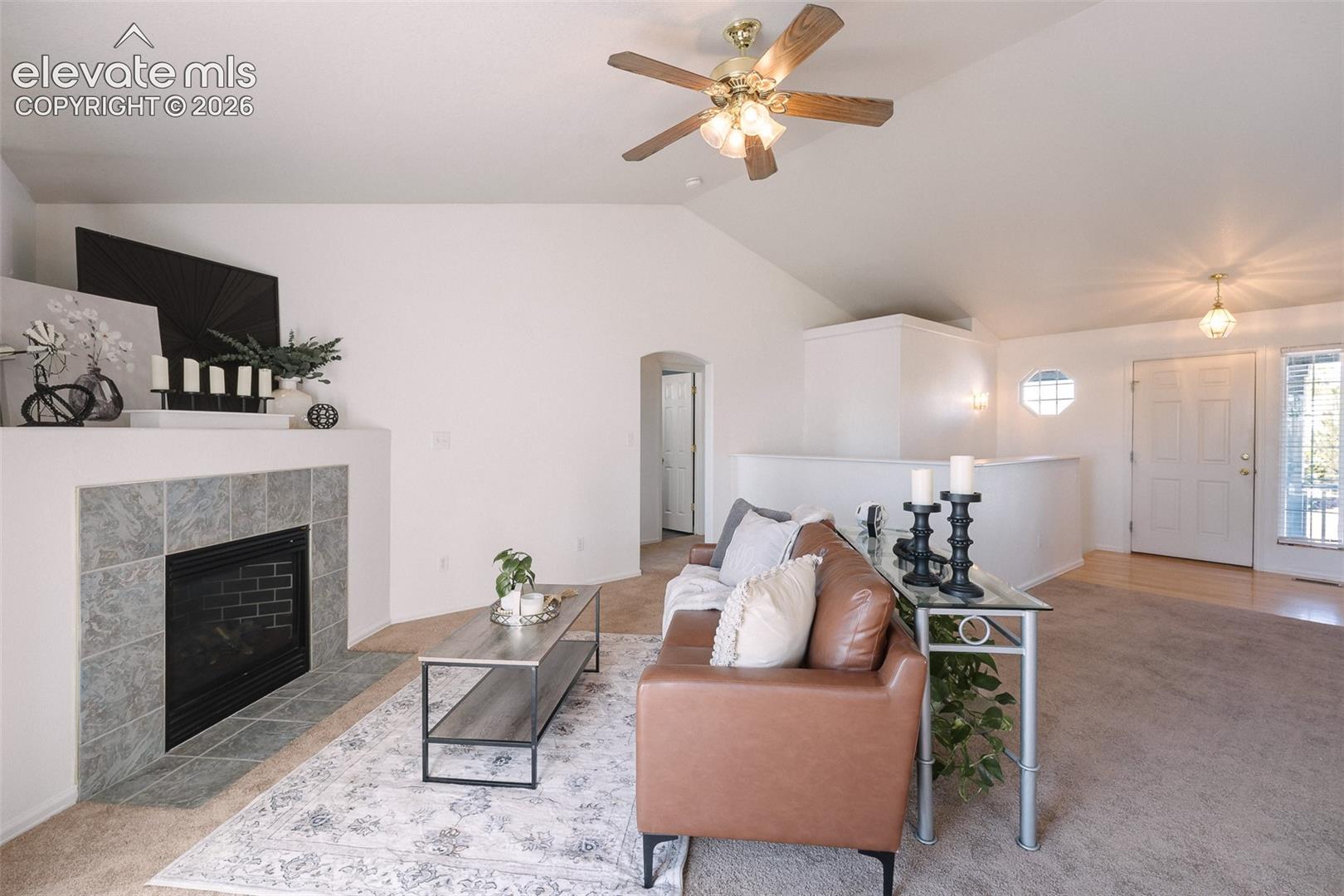 7869 Fort Smith Road Peyton, CO 80831 - Photo 14 of 50 Soaring ceilings, abundant natural light, and a cozy fireplace create a living space that feels both open and inviting.