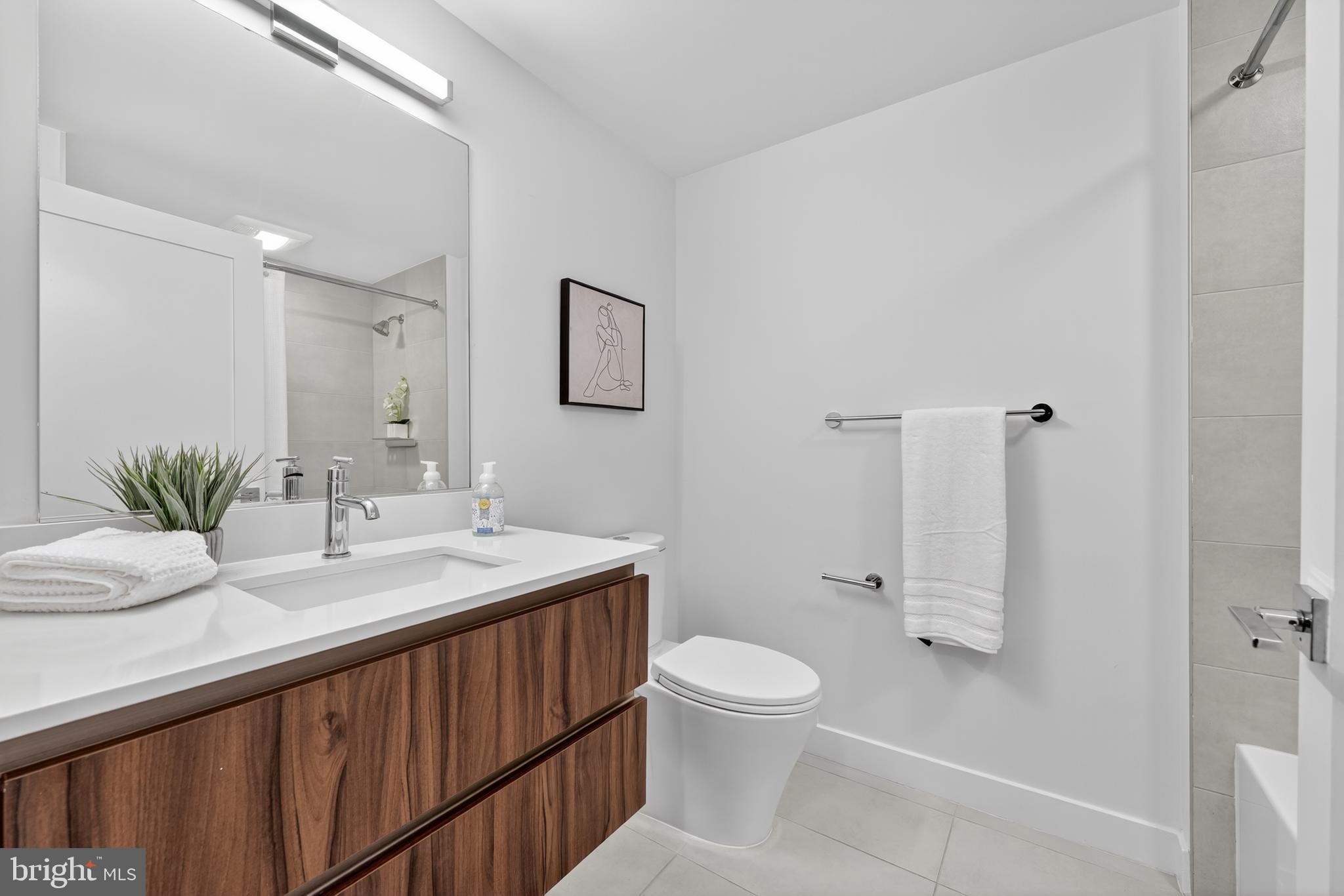 37 L Street Southeast, Unit A701 Washington, DC 20003 - Photo 13 of 45 a bathroom with a sink toilet and shower