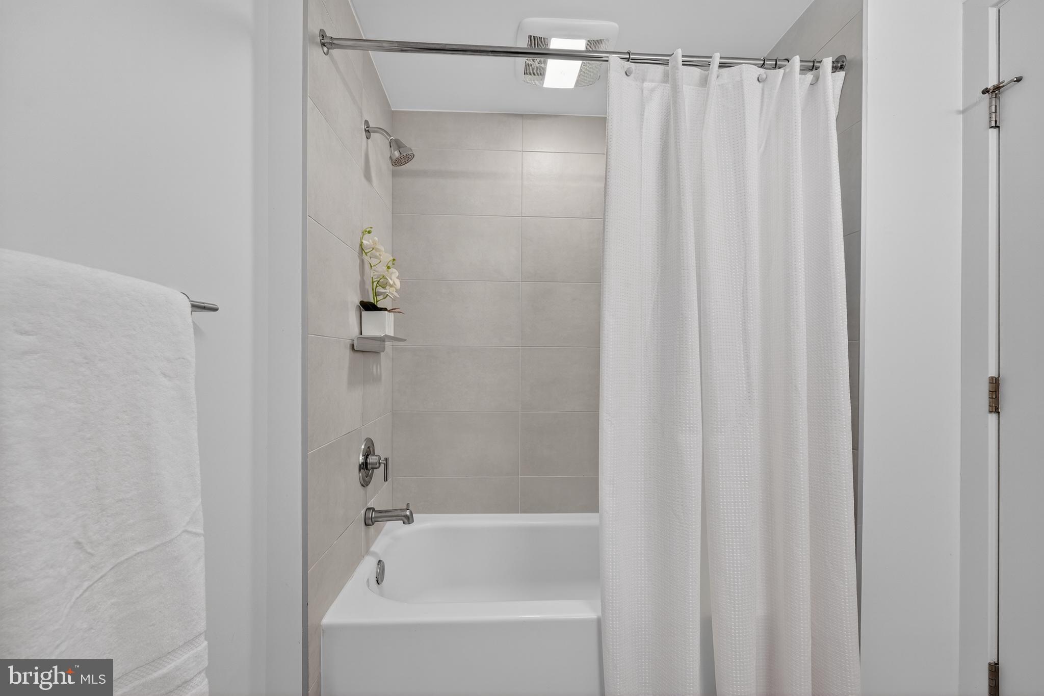 37 L Street Southeast, Unit A701 Washington, DC 20003 - Photo 14 of 45 a bathroom with a shower and a bath tub