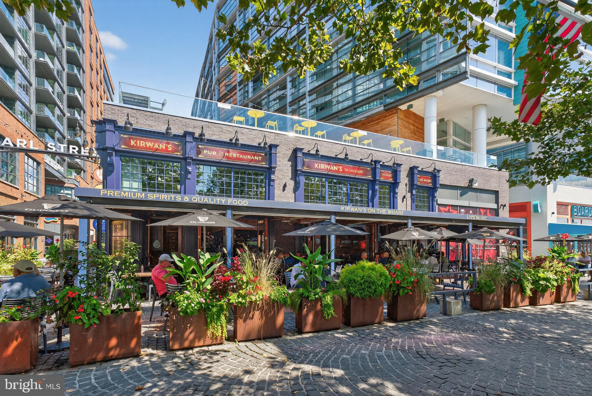 37 L Street Southeast, Unit A701 Washington, DC 20003 - Photo 42 of 45 a street view with tall buildings and a flower garden