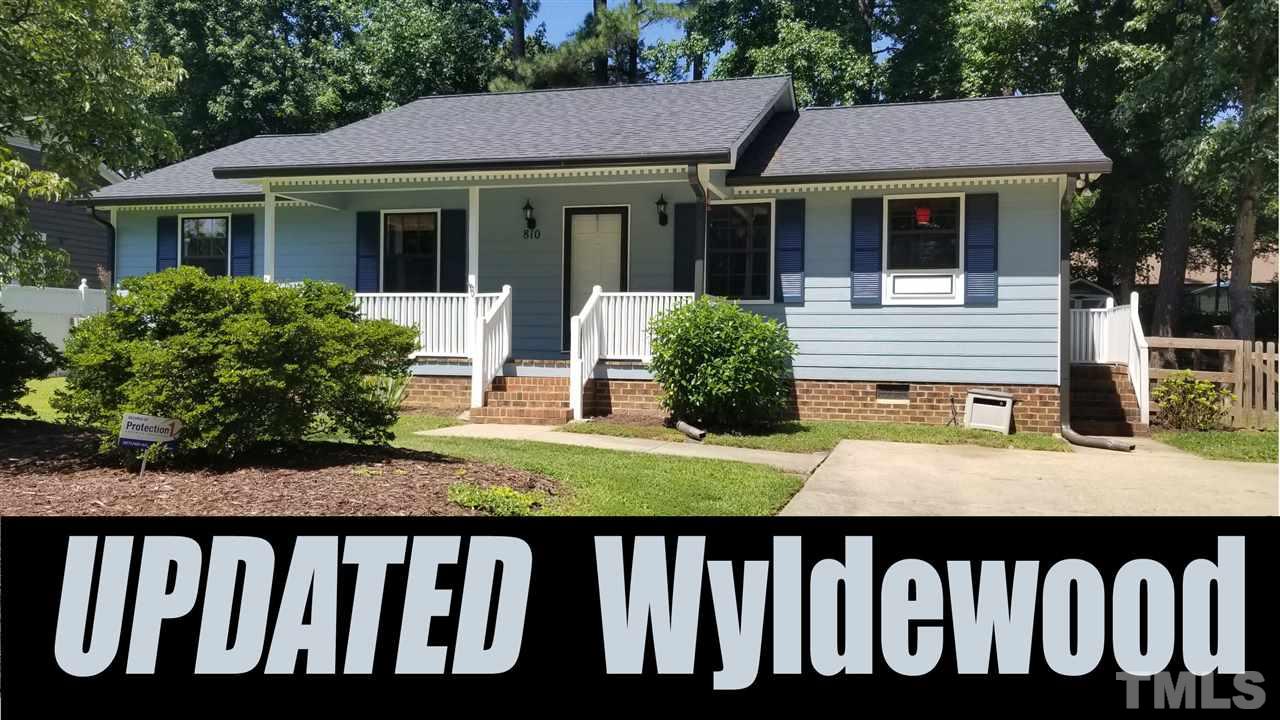 a front view of house with deck and outdoor seating