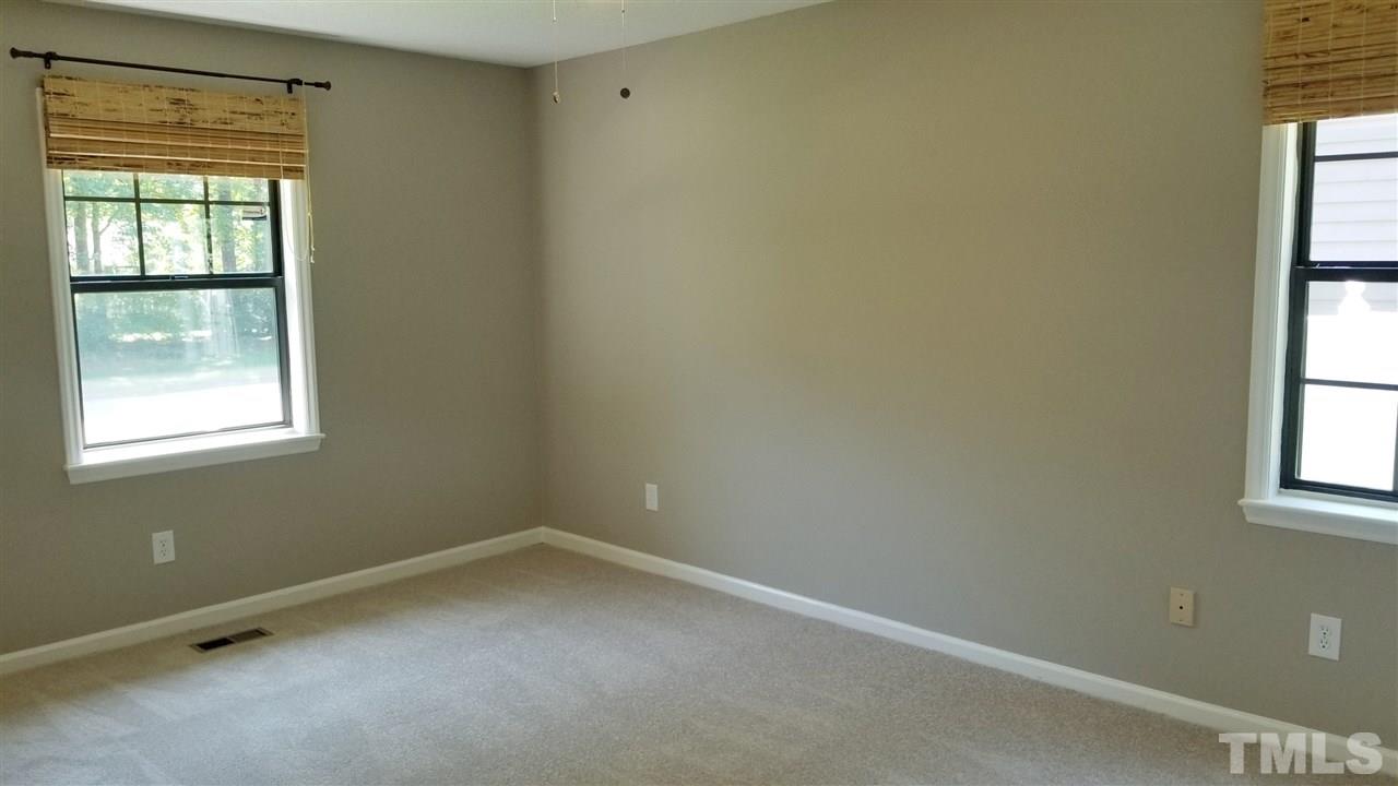 810 Wyldewood Road Durham, NC 27704 - Photo 11 of 23 an empty room with a window
