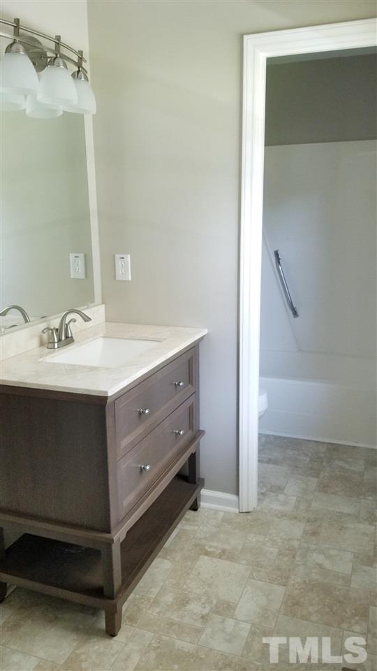 810 Wyldewood Road Durham, NC 27704 - Photo 13 of 23 a bathroom with a sink and a mirror