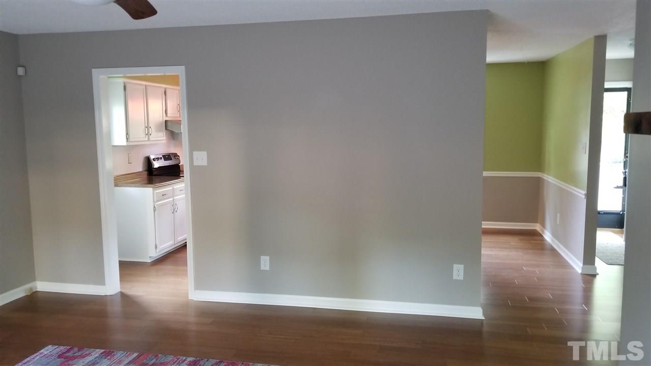 810 Wyldewood Road Durham, NC 27704 - Photo 5 of 23 a view of a hallway with wooden floor and closet