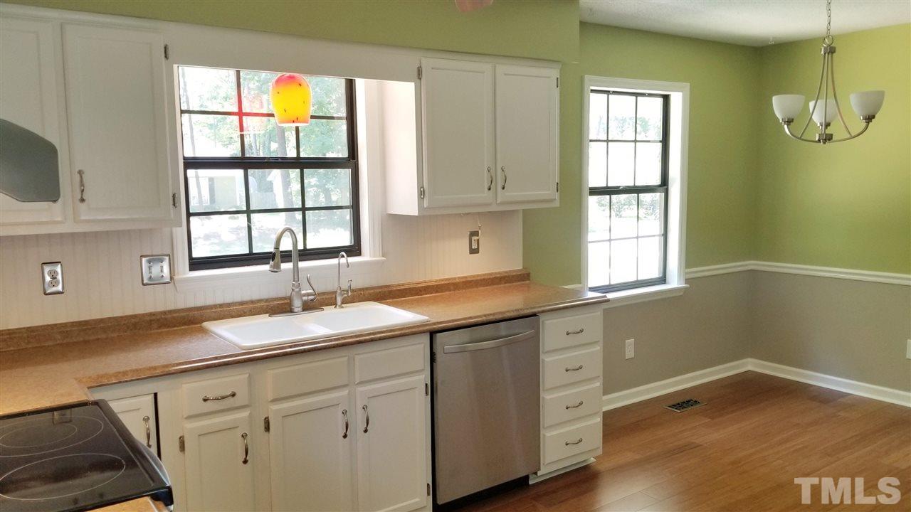 810 Wyldewood Road Durham, NC 27704 - Photo 7 of 23 a kitchen with a sink cabinets and window