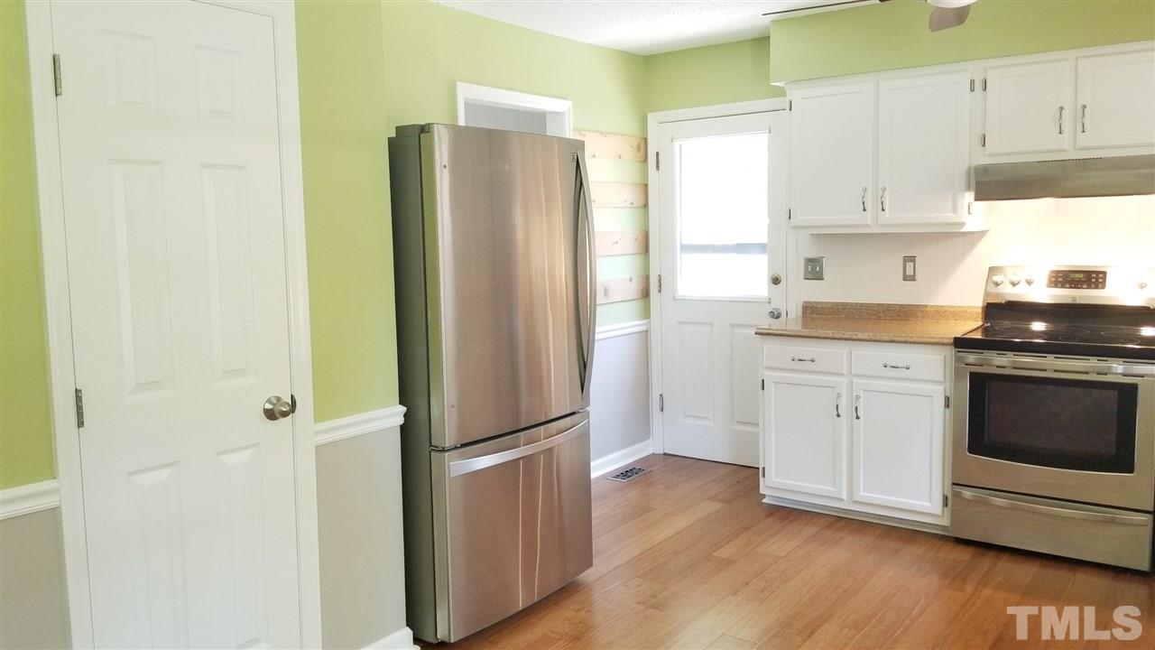 810 Wyldewood Road Durham, NC 27704 - Photo 8 of 23 a kitchen with a refrigerator sink and cabinets