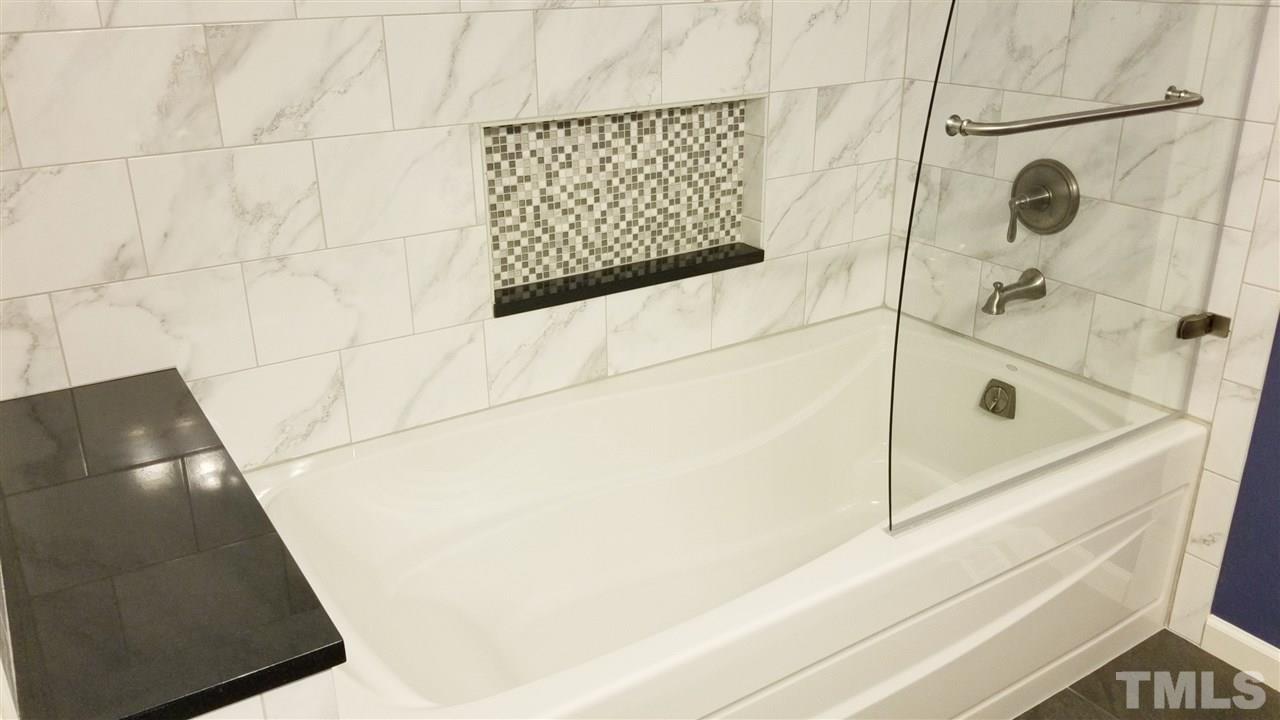 810 Wyldewood Road Durham, NC 27704 - Photo 10 of 23 a bathroom with a tub and shower