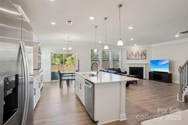 a large kitchen with stainless steel appliances granite countertop a stove oven and a refrigerator