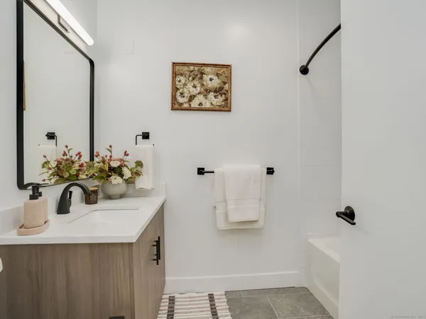 a bathroom with a sink a mirror and shower