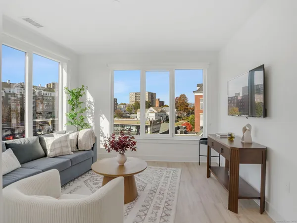 a living room with furniture and a large window