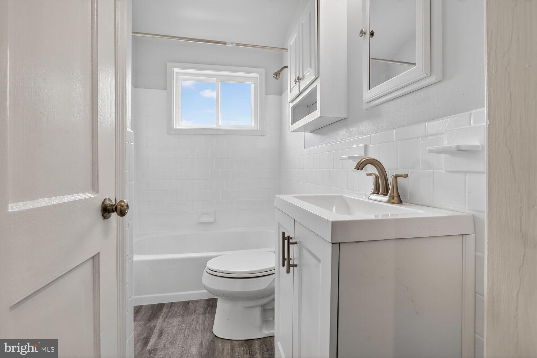 8258 Kavanagh Road Baltimore, MD 21222 - Photo 15 of 19 a bathroom with a sink toilet and shower
