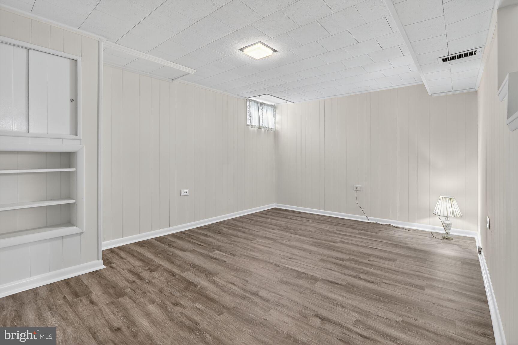 8258 Kavanagh Road Baltimore, MD 21222 - Photo 16 of 19 a view of empty room with wooden floor and fan