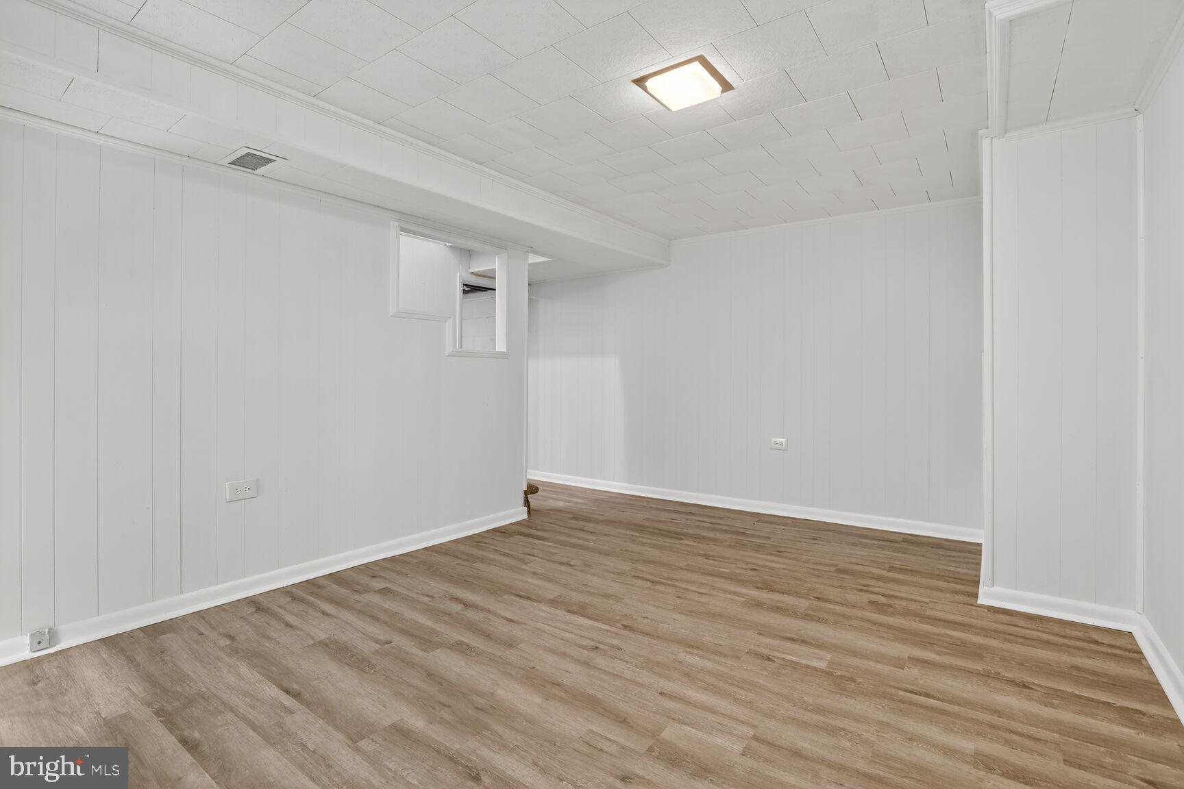 8258 Kavanagh Road Baltimore, MD 21222 - Photo 17 of 19 wooden floor in a empty room