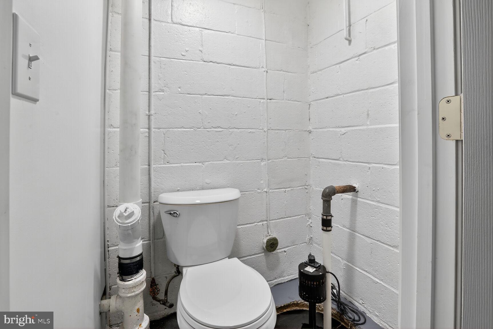 8258 Kavanagh Road Baltimore, MD 21222 - Photo 19 of 19 a white toilet sitting next to a bathroom sink