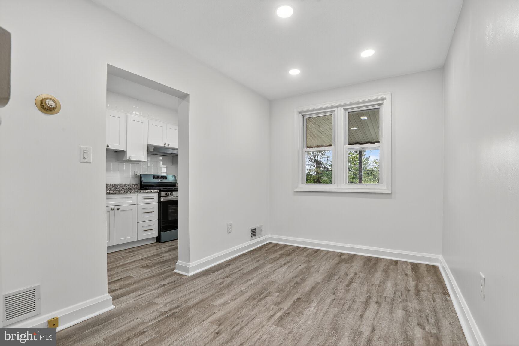 8258 Kavanagh Road Baltimore, MD 21222 - Photo 6 of 19 a kitchen with a refrigerator and a stove top oven