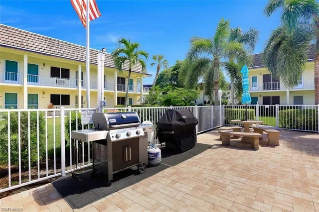 a couple of table and chairs in front of house