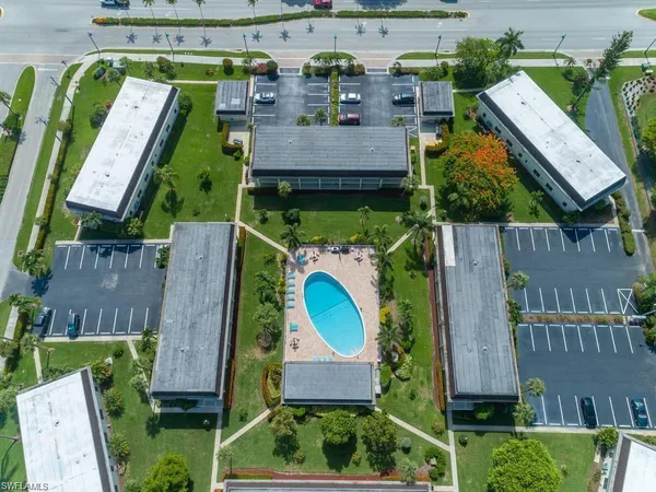 an aerial view of multiple houses with yard