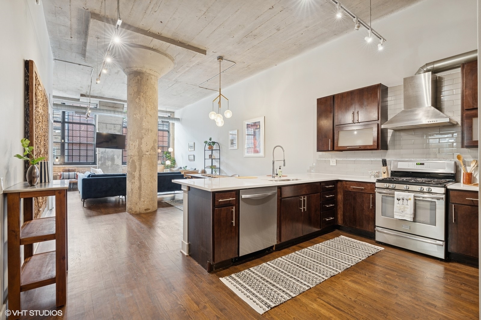 17 North Loomis Street, Unit 1C Chicago, IL 60607 - Photo 12 of 24 a large kitchen with stainless steel appliances granite countertop a stove and a wooden floors