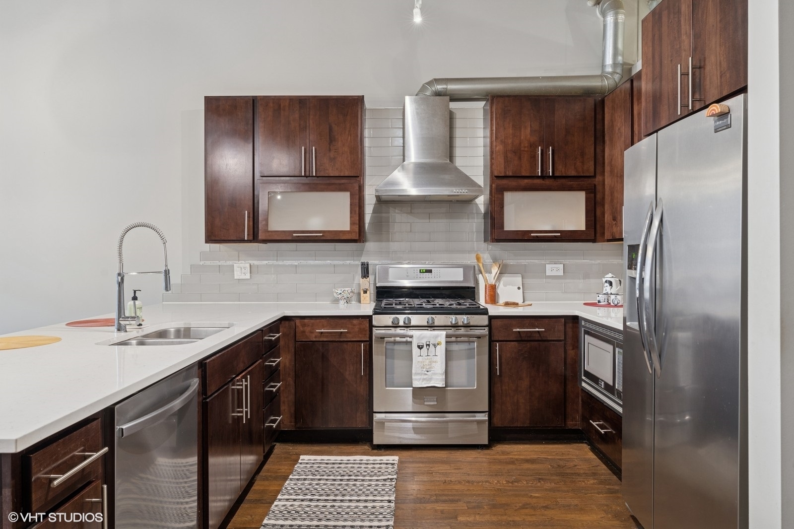 17 North Loomis Street, Unit 1C Chicago, IL 60607 - Photo 13 of 24 a kitchen with stainless steel appliances granite countertop a sink stove and refrigerator