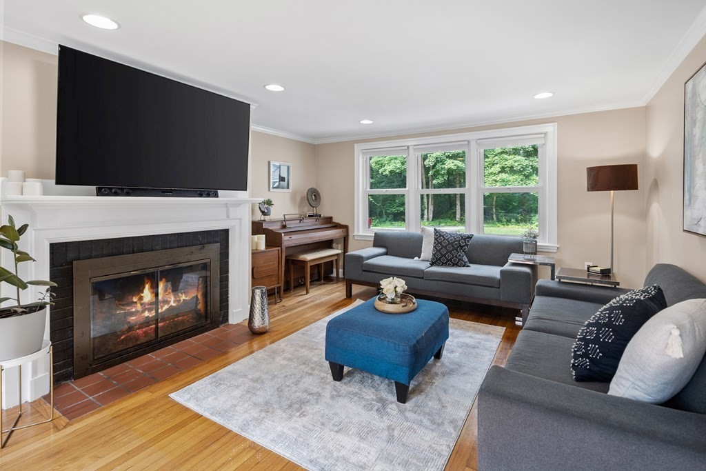 143 Boston Post Road Wayland, MA 01778 - Photo 3 of 17 a living room with furniture a flat screen tv and a fireplace