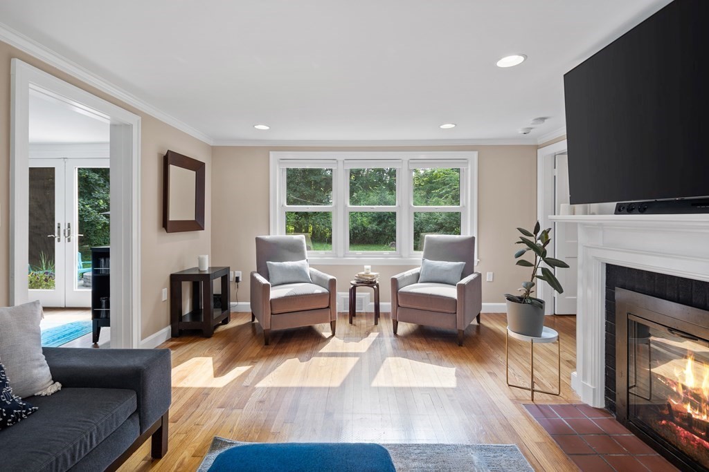 143 Boston Post Road Wayland, MA 01778 - Photo 4 of 17 a living room with furniture a flat screen tv and a fireplace