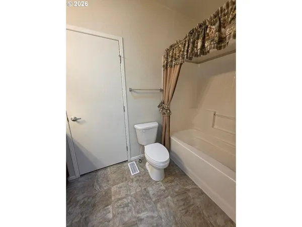 a bathroom with a double vanity sink toilet and shower