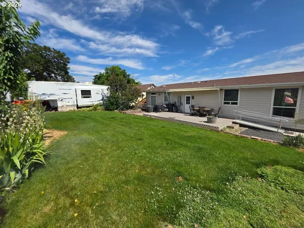 a view of a backyard with sitting area