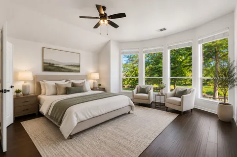 a spacious bedroom with a large bed and a couch