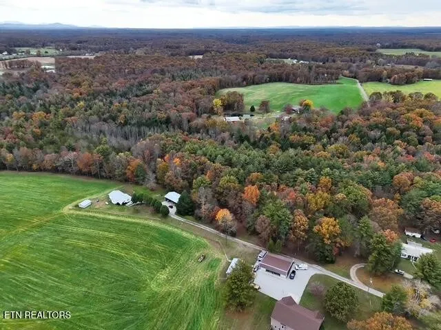 an aerial view of a houses with a yard