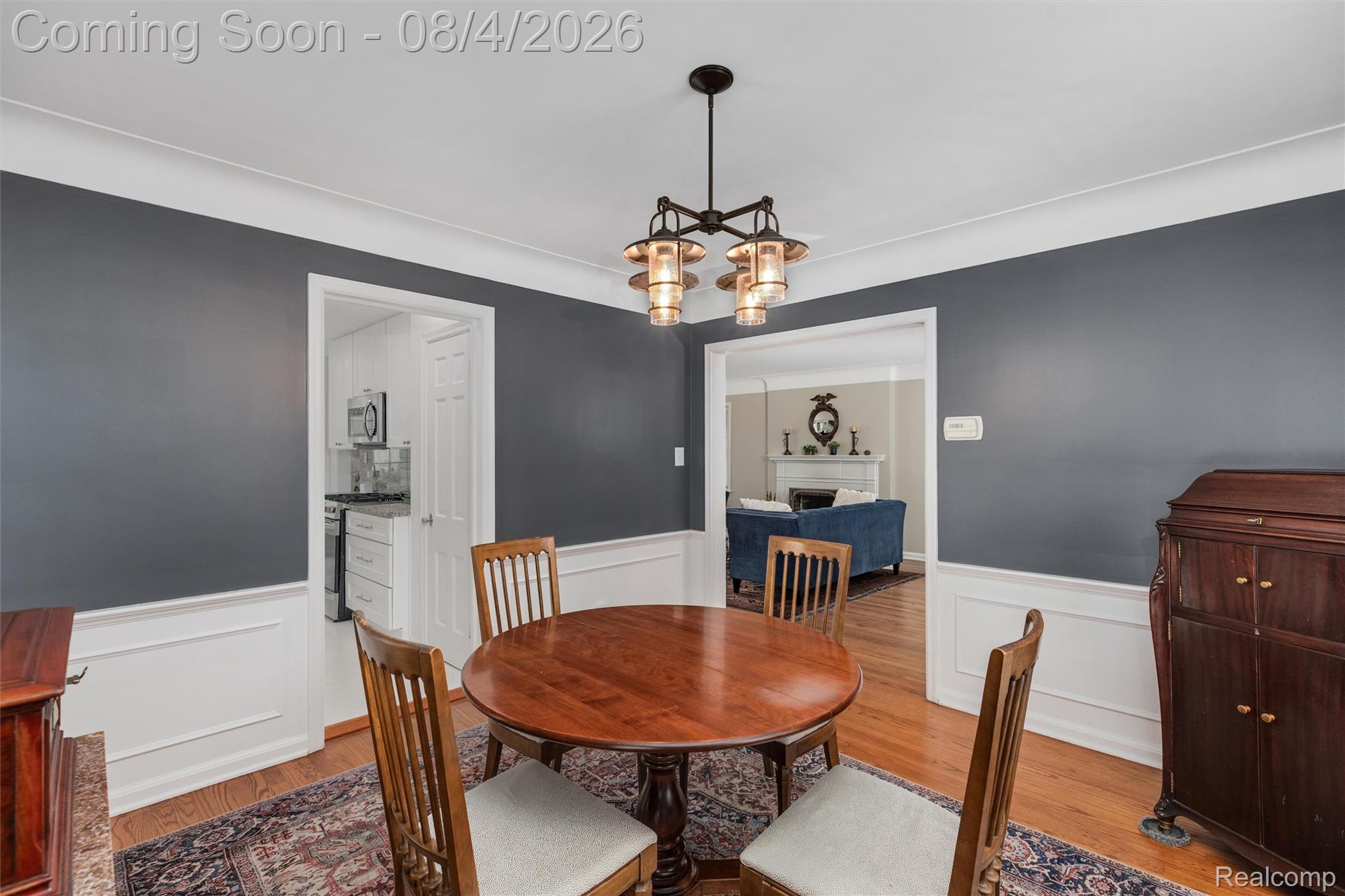 1729 Broadstone Road Grosse Pointe, MI 48236 - Photo 15 of 39 Dining area featuring hardwood flooring, an overhead light fixture, and crown molding
