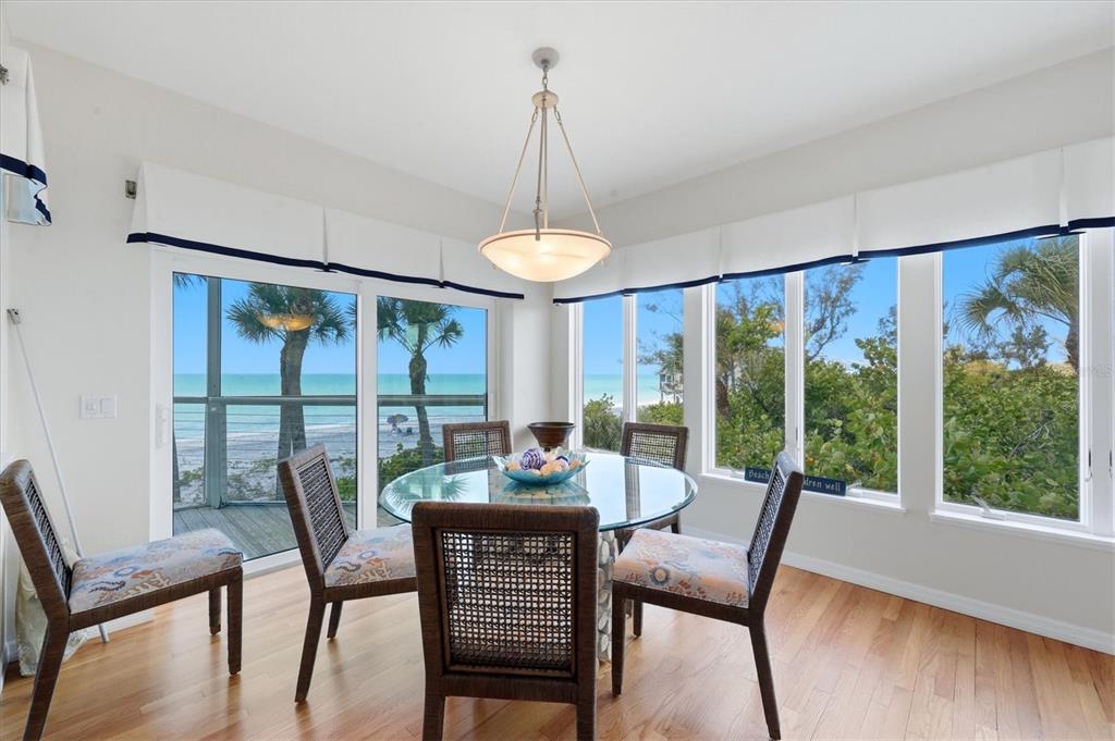 400 South Gulf Boulevard Boca Grande, FL 33921 - Photo 16 of 80 a dining room with furniture large windows and wooden floor