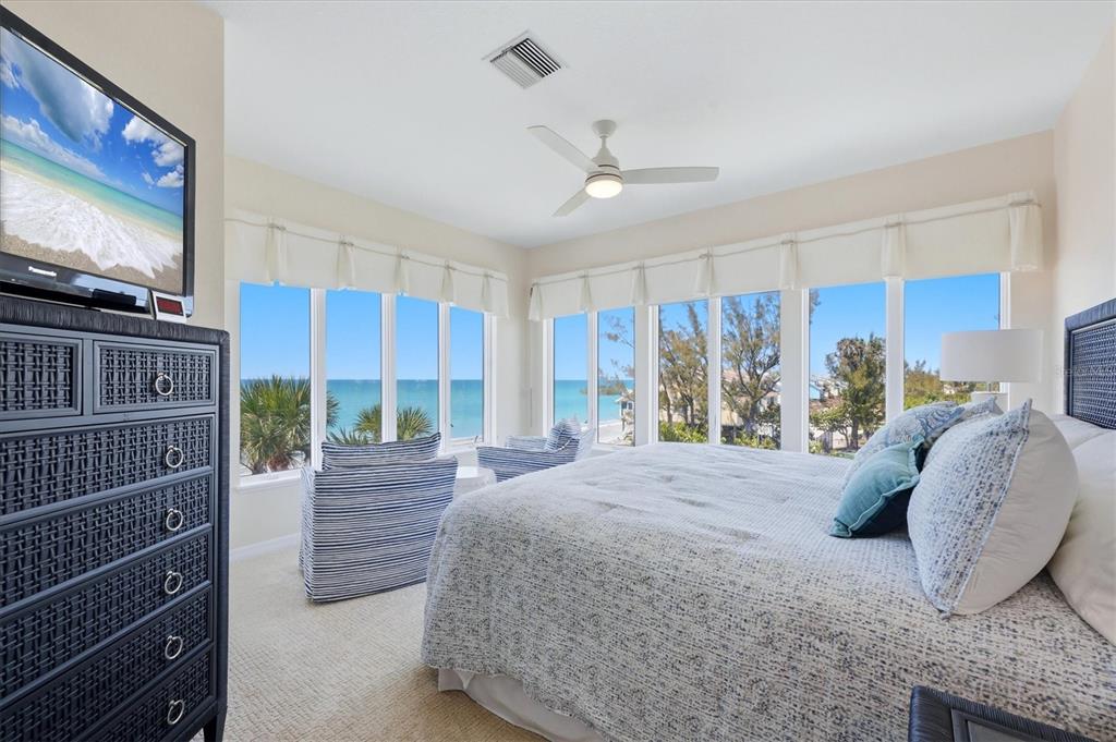 400 South Gulf Boulevard Boca Grande, FL 33921 - Photo 26 of 80 a bedroom with a large bed and a flat tv screen on dresser