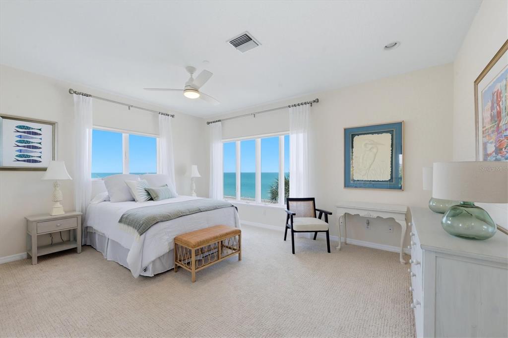 400 South Gulf Boulevard Boca Grande, FL 33921 - Photo 34 of 80 a spacious bedroom with a bed and a table in it