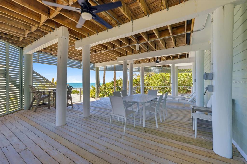 400 South Gulf Boulevard Boca Grande, FL 33921 - Photo 54 of 80 a view of a patio with table and chairs and wooden floor