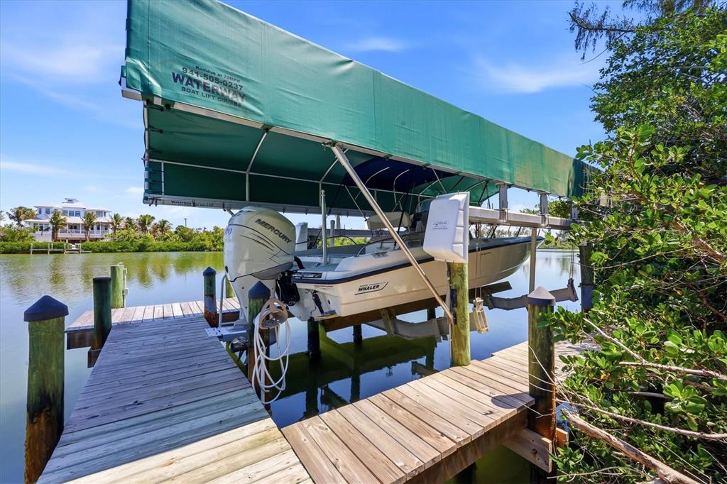 400 South Gulf Boulevard Boca Grande, FL 33921 - Photo 59 of 80 a view of a roof deck with table and chairs a barbeque with wooden floor and fence