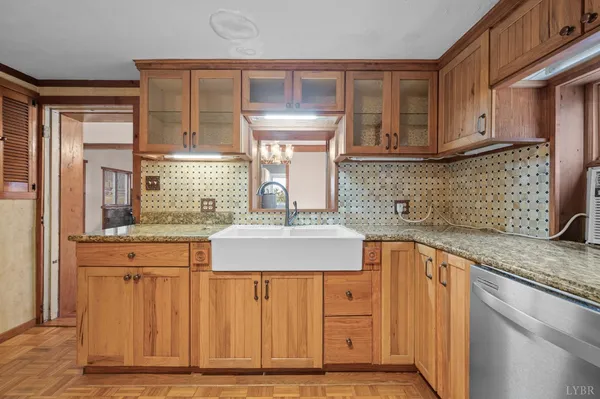 a kitchen with granite countertop a sink and cabinets