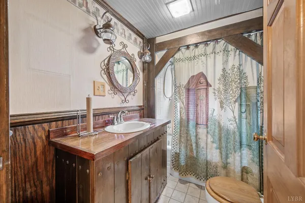 a bathroom with a sink a toilet and a shower
