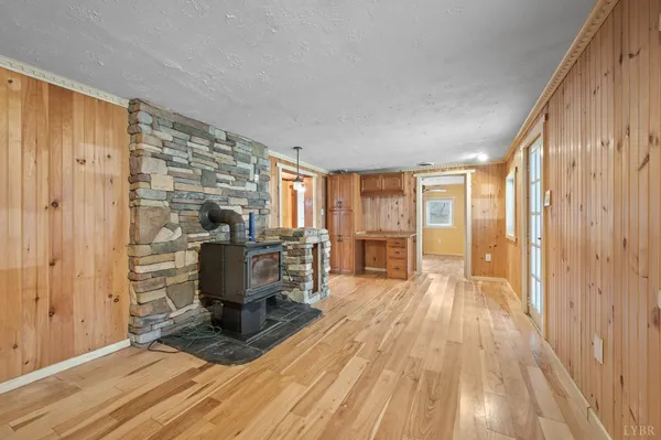 a view of a living room hardwood floor and a kitchen