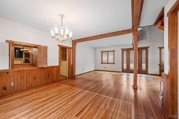 a view of a room with wooden floor and staircase