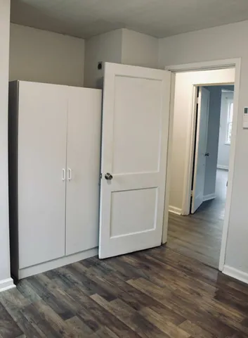 a view of a room with wooden floor
