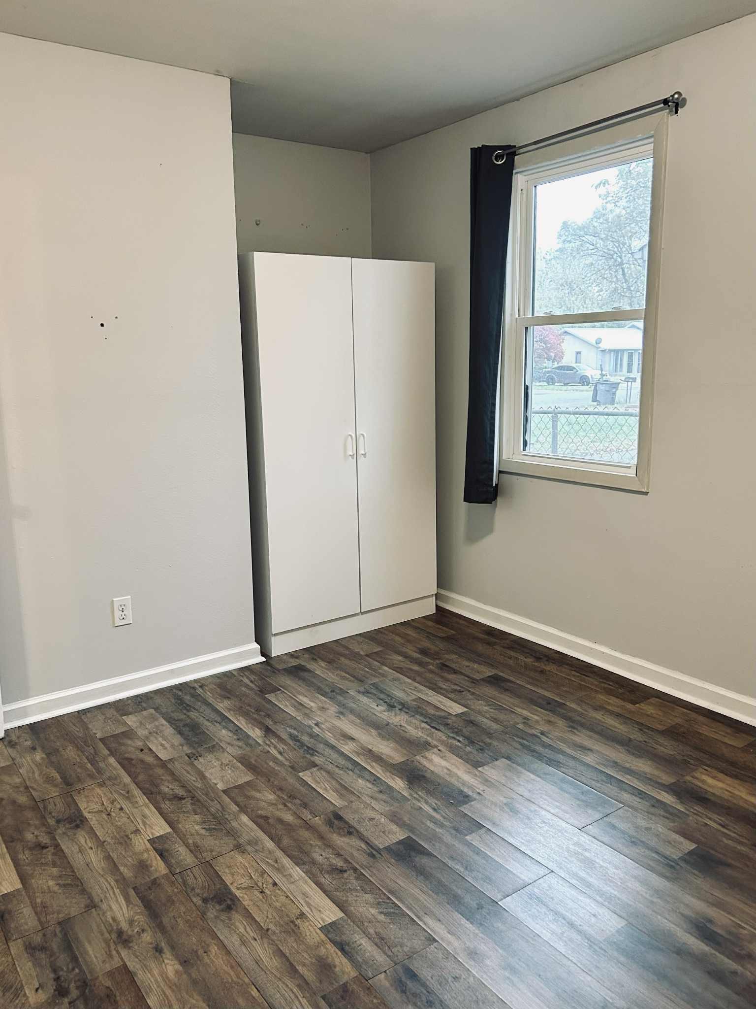 221 Burch Road Clarksville, TN 37042 - Photo 20 of 29 a view of an empty room with wooden floor and a window