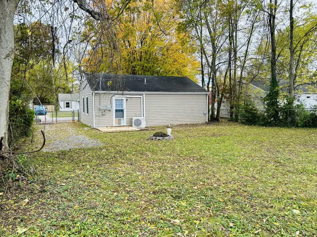 a view of backyard with swimming pool and seating space
