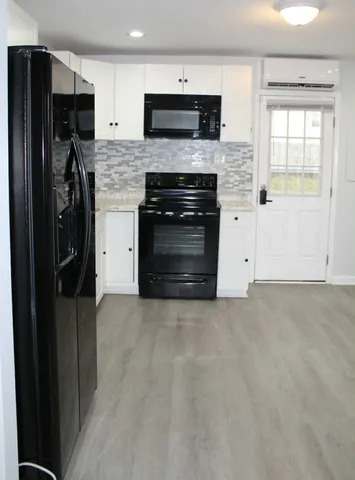 a kitchen with stainless steel appliances granite countertop a refrigerator and a stove top oven