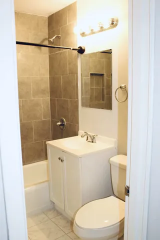 a bathroom with a sink a toilet and mirror